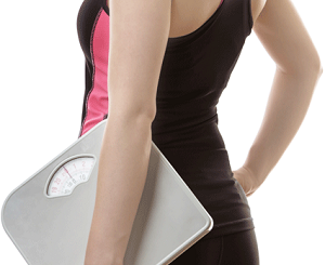 Fit Woman With Weighing Scale