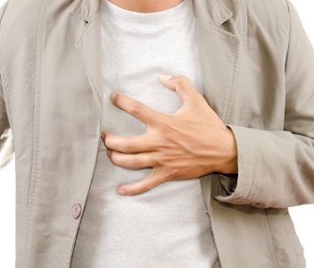 Man Pressing Chest Because of Heartburn Pain