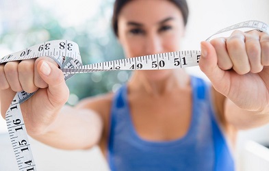 Woman Holding Showing Tape Measure