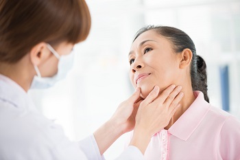 Doctor Examining Patient Thyroid